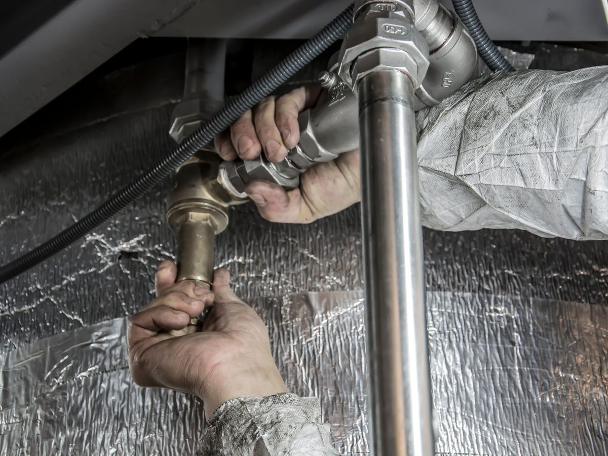 Plumber's hands fitting pipe connectors together